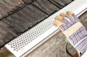 a gutter protection screen being added to gutters