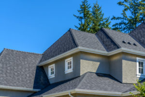 a newly installed asphalt shingle roof on large family home